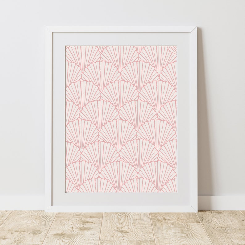 May include: A white frame with a pink and white geometric pattern print. The pattern is made up of overlapping fan shapes.