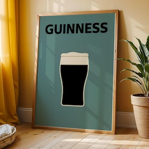May include: A framed poster with a minimalist design of a pint of Guinness stout. The black beer contrasts with the white foam, set against a teal background. The word "GUINNESS" is printed in bold black letters at the top.