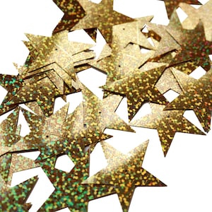 May include: A pile of gold star-shaped sequins with a glittery finish.