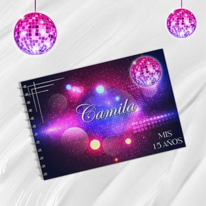 以下が含まれることがあります： 鮮やかな色彩のデザインの、スパイラル綴じノート。表紙には「Camila」という名前がエレガントな筆記体で書かれ、その下に「MIS 15 AÑOS」という文字があります。デザインにはディスコボールと、紫、ピンク、青の色合いの背景が含まれています。