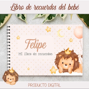 Puede incluir: Un libro de recuerdos para bebé de color rosa y blanco con una ilustración de un león que lleva una corona. El libro tiene una encuadernación en espiral y el texto "Felipe Mi libro de recuerdos" está impreso en la portada.