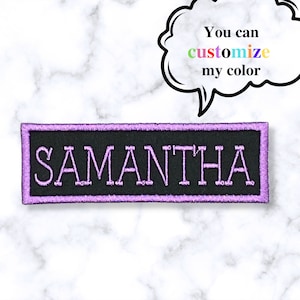 May include: A black rectangular patch with a purple border and the name "SAMANTHA" embroidered in white.