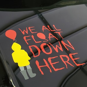 May include: Red and white vinyl sticker with the text "We all float down here" and a yellow figure with a red balloon.