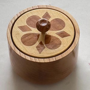 Salt Cellar made of American Ash, maple with Cherry inlay lid and a Olive wood knob.