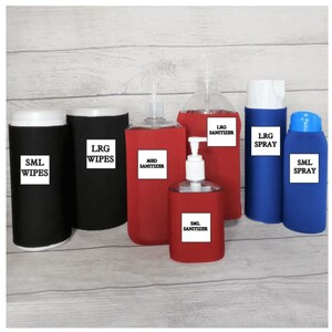 May include: A collection of various sized black and red containers, including wipes, sanitizers, and spray bottles. Each container has a white label indicating its size and contents. The bottles are arranged on a light wood-grain surface.