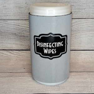 May include: A gray and white container with a black label that says "DISINFECTING WIPES".