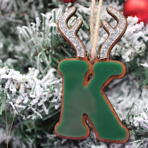 May include: Green wooden letter K Christmas ornament with silver glitter reindeer antlers.