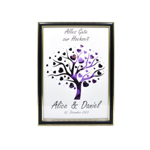 May include: Framed art print featuring a tree design with heart-shaped leaves in black and purple. The text "Alles Gute zur Hochzeit" is at the top, with "Alice & Daniel" and the date below. The frame is black with a gold inner edge.