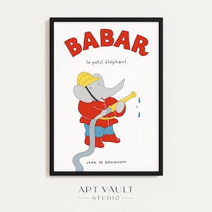 May include: A framed print featuring Babar the elephant in a firefighter's uniform, holding a yellow hose. The word "BABAR" is in red block letters above the image, with "le petit éléphant" below. The artist's name, Jean de Brunhoff, is also visible.