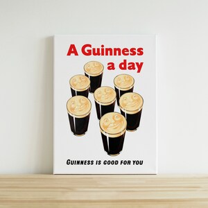 May include: A vintage Guinness advertisement featuring the slogan "A Guinness a day" and the tagline "Guinness is good for you". The ad depicts six glasses of Guinness with smiling faces.