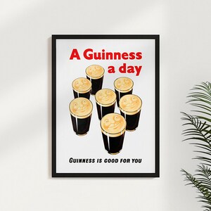 May include: A vintage Guinness poster with the text "A Guinness a day, Guinness is good for you". The poster features a white background with seven glasses of Guinness, each with a smiling face in the foam.