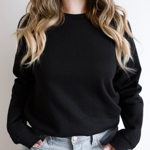 May include: A black long-sleeved sweatshirt with a crew neck.