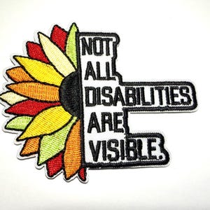 May include: Embroidered patch featuring a colorful sunflower design with the text "NOT ALL DISABILITIES ARE VISIBLE" in black and white. The sunflower petals transition from red to yellow and orange.