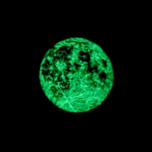 May include: A glowing green sphere against a black background. The sphere has a textured surface with intricate patterns, resembling a celestial body. The bright green color contrasts sharply with the dark backdrop.