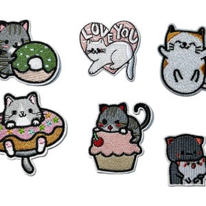 May include: Set of six embroidered patches featuring adorable cartoon cats. Designs include a cat with a donut, a cat inside a donut, a cat on a cupcake, a cat with a heart that says "Love You", and a cat with a bow.