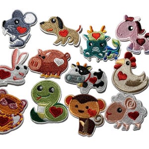 May include: A collection of embroidered patches featuring various animals, including a mouse, dog, rabbit, pig, dragon, horse, cow, chicken, bear, snake, monkey, and sheep. Each patch has a heart design. The patches are colorful and detailed.
