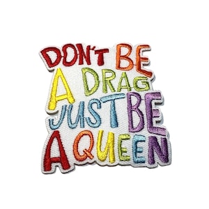 May include: Embroidered patch with the text "DON'T BE A DRAG JUST BE A QUEEN" in rainbow colors. The patch is white with a colorful, embroidered design, perfect for adding to clothing or accessories.
