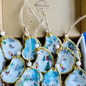 May include: A handmade wooden sign with the text "Welcome" in a playful font. The sign is painted white with a distressed finish, and features a decorative floral design in shades of pink and green. It measures approximately 12 inches wide.