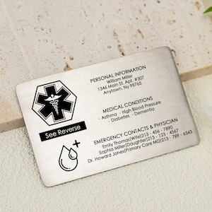 May include: A silver medical alert card with a black star of life symbol, a black drop of blood symbol, and the text "See Reverse". The card includes personal information, medical conditions, and emergency contacts and physician information.