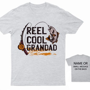 May include: Gray t-shirt with a fishing rod and fish graphic. The text "Reel Cool Grandad" is printed on the shirt.