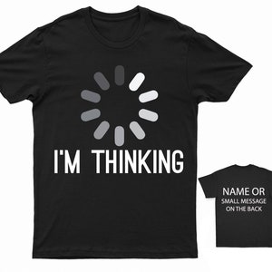 May include: Black t-shirt with a white loading icon and the text "I'M THINKING". The back of the shirt has space for a name or small message.