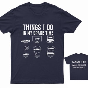 K&ouml;nnte beinhalten: Marineblaues T-Shirt mit einer wei&szlig;en Grafik, auf der "Things I do in my spare time" steht und Aktivit&auml;ten im Zusammenhang mit Autos aufgelistet sind. Die Grafik enth&auml;lt Illustrationen von Autos, einem Computer und einem Bett. Die R&uuml;ckseite des Shirts ist leer.