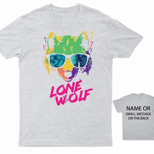 May include: Gray t-shirt with a colorful wolf wearing sunglasses and the text "LONE WOLF" in pink letters.