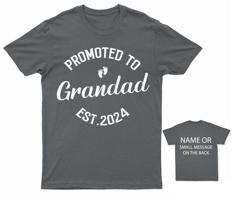 May include: A dark gray t-shirt with white text that reads "Promoted to Grandad Est. 2024" with a pair of white footprints above the word "Grandad". The back of the shirt has a small white text that reads "Name or small message on the back".