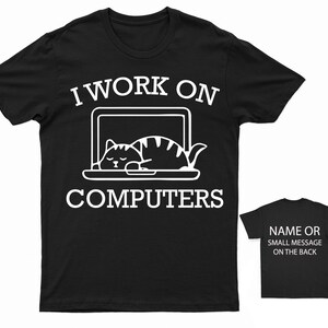 May include: Black t-shirt with white text that reads "I work on computers" and a graphic of a cat sleeping on a laptop.