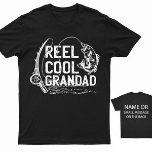 May include: Black t-shirt with white text that reads "Reel Cool Grandad" and a graphic of a fish being reeled in.