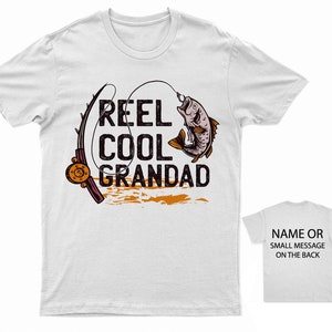 May include: White t-shirt with a fishing rod and fish graphic. The text "Reel Cool Grandad" is printed on the shirt. A second white t-shirt is shown with the text "Name or Small Message on the Back".