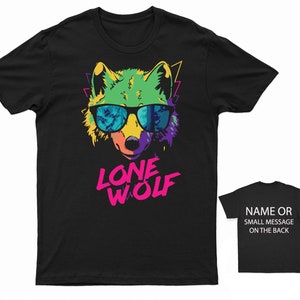 May include: Black t-shirt with a colorful graphic of a wolf wearing sunglasses and the text "LONE WOLF" in pink and white.