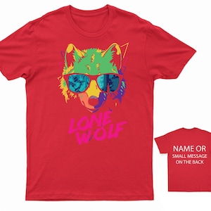 May include: Red t-shirt with a colorful graphic of a wolf wearing sunglasses and the text "LONE WOLF".