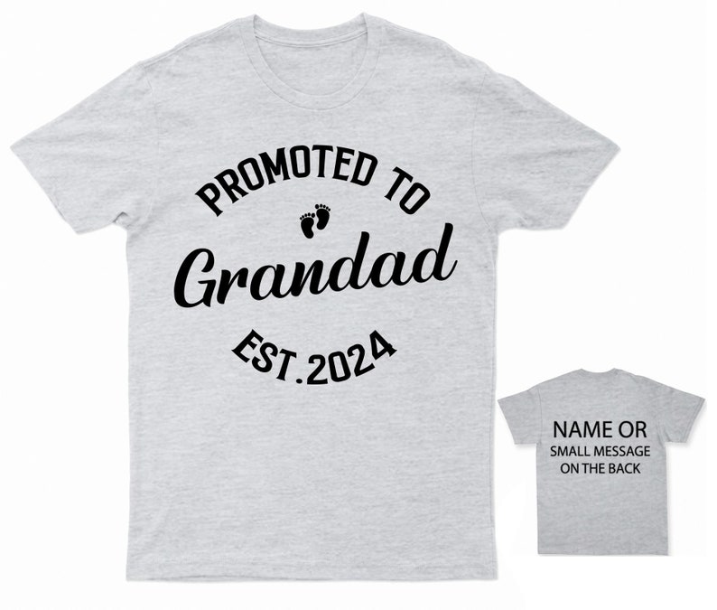 May include: Gray t-shirt with black text that reads "Promoted to Grandad Est. 2024" with a pair of baby footprints above the word "Grandad".