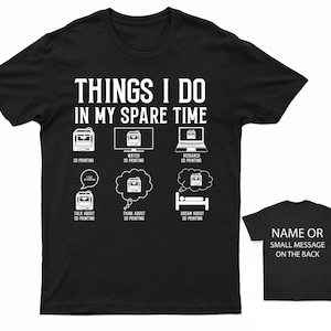 May include: Black t-shirt with white text that reads "Things I do in my spare time". The shirt features a series of icons depicting 3D printing activities, including 3D printing, watching 3D printing, researching 3D printing, talking about 3D printing, thinking about 3D printing, and dreaming about 3D printing.