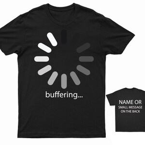 May include: Black t-shirt with a white loading icon and the text "buffering..." printed on the front. The back of the shirt has space for a name or small message.