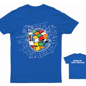 May include: A royal blue t-shirt featuring a colourful Rubik's Cube design and white mathematical equations printed on the front. The back of the shirt is plain royal blue with the text "NAME OR SMALL MESSAGE" printed in white.