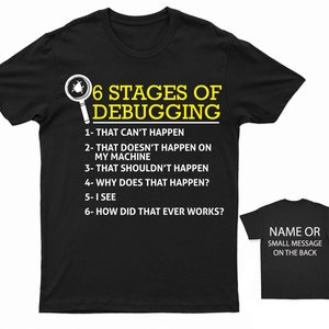 May include: Black t-shirt with yellow text that reads "6 Stages of Debugging" and lists the stages: "1- That can't happen", "2- That doesn't happen on my machine", "3- That shouldn't happen", "4- Why does that happen?", "5- I see", "6- How did that ever works?"