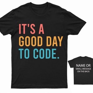 May include: Black t-shirt with the text "It's a good day to code." in rainbow colours. The text is in a retro font style.