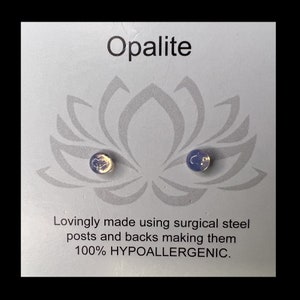 May include: A pair of opalite stud earrings on a card with a lotus flower design. The card reads "Opalite" and "Lovingly made using surgical steel posts and backs making them 100% HYPOALLERGENIC."