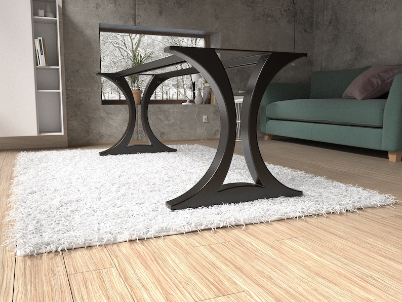 May include: A black metal table base featuring two large, curved, arch-shaped supports connected by a horizontal frame. The structure has a smooth, matte finish and a wide, stable footprint designed to support a tabletop surface.