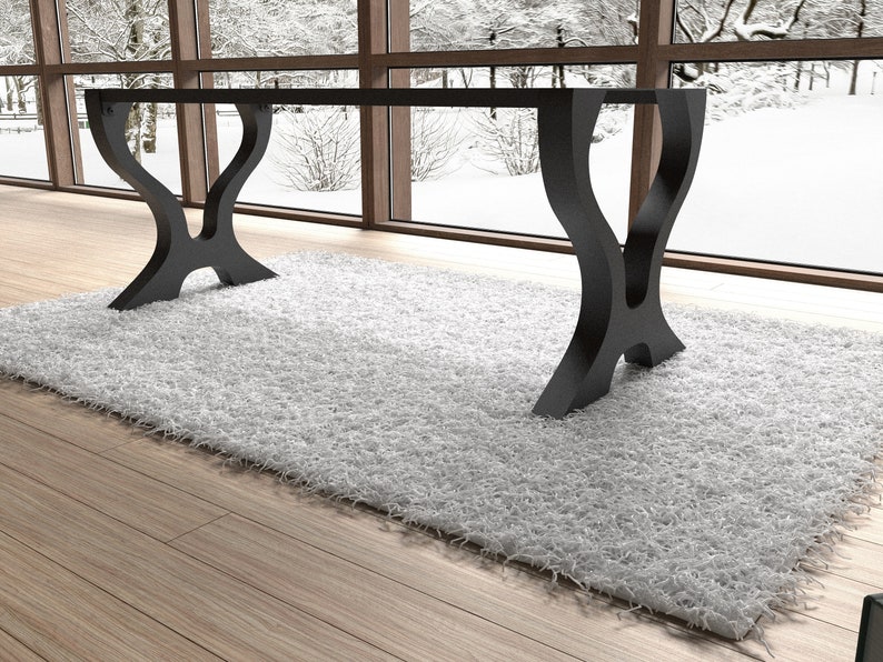May include: A black, modern dining table with a rectangular glass top and two unique, curved, black metal legs. The table is sitting on a white shag rug.