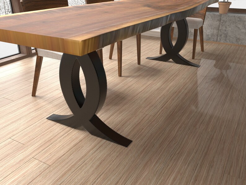 Puede incluir: Una mesa de comedor de madera con una tapa de borde vivo y dos patas de metal negro. Las patas tienen forma de ocho.