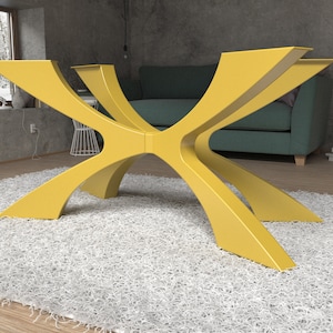 May include: A modern, yellow table base with a unique, geometric design. The base has multiple curved legs that intersect in the center, creating an eye-catching, sculptural form. The table base is shown on a white rug.