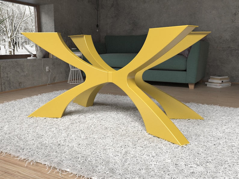 May include: A modern, yellow table base with a unique, geometric design. The base has multiple curved legs that intersect in the center, creating an eye-catching, sculptural form. The table base is shown on a white rug.
