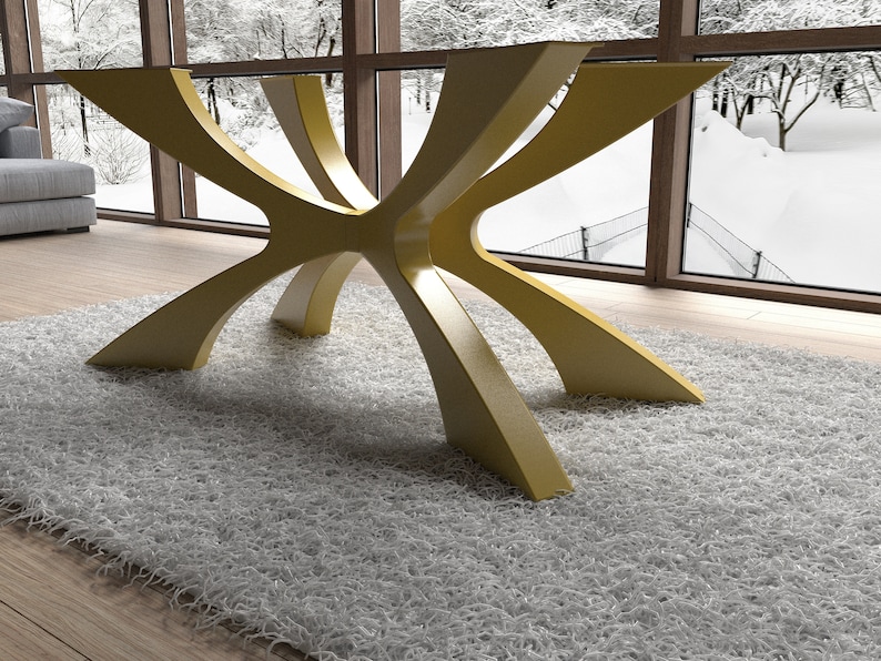 May include: A modern table base with a unique design. The base is made of a light yellow material and features an intricate, starburst-like structure. The table is set on a fluffy, white rug in front of a large window.