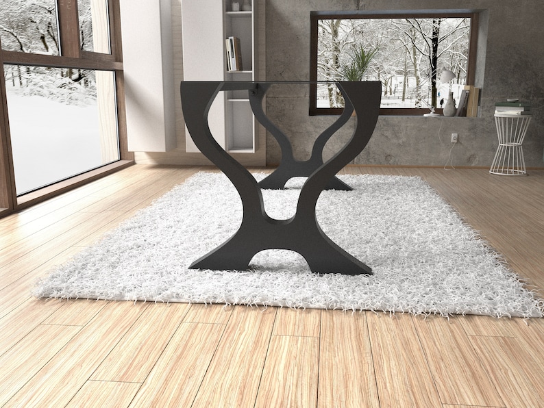 May include: A black glass table with a unique, abstract, curved base. The table is sitting on a white shag rug in a room with a large window.