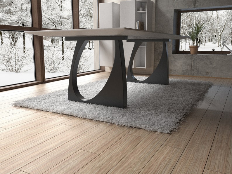 May include: A white rectangular dining table with a modern design. The table has a white top and black metal legs with a unique curved shape. The table is set on a white fluffy rug in a room with wooden floors.