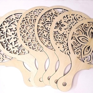 May include: Set of six wooden stencils with intricate floral and geometric designs. Each stencil has a handle for easy use.