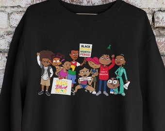 May include: Black sweatshirt with a graphic print of cartoon characters holding signs that say "Black History Month Period" and "I Can't Breathe".